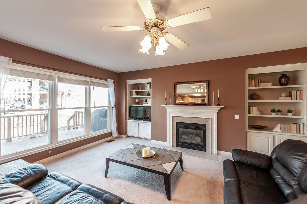 THe Family room / den area offers a gas fireplace, builtin bookcases and a wall of windows overlooking the deck and Old Hickory Lake making for relaxing evenings and sunset views a part of your daily lifestyle while watching wildlife along the shore.