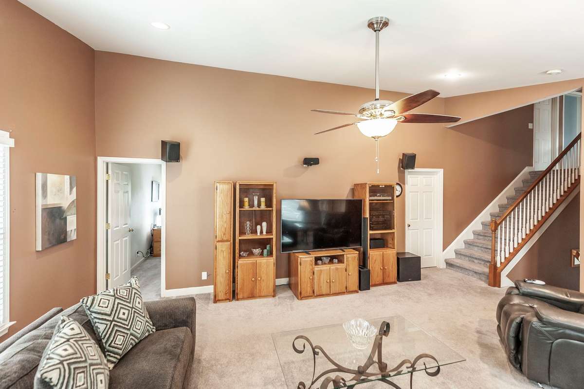 This view of the Bonus room is showing the entry to the bedroom/office and utility room before heading up a short flight of steps to the bedroom area of the home.