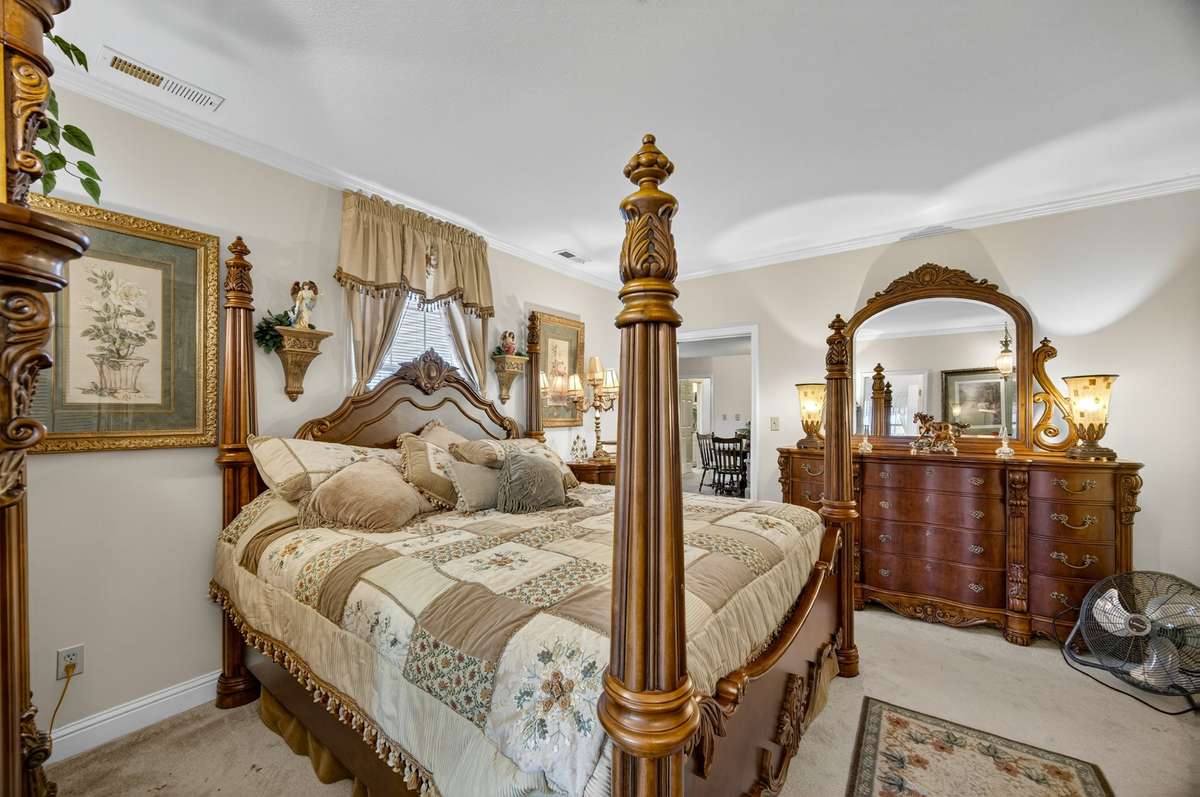 Downstairs guest bedroom offering comfortable proportions, natural light, and flexible layout for guest accommodations; furnishings may be included, partially included, or removed based on buyer preference.