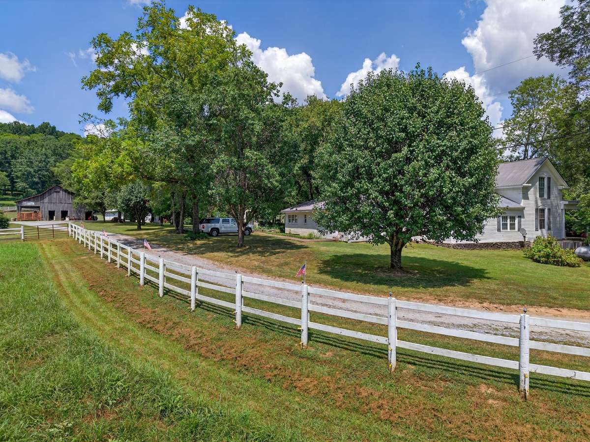 Private drive through fenced pasture and mature trees, leading to the historic farmhouse on 164± acres.