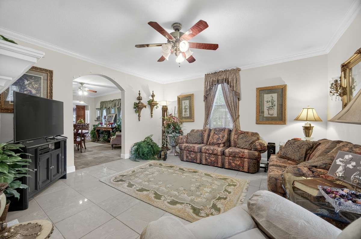 Living room offering a fireplace centerpiece, flexible layout, and ample space for gathering; furnishings may be included, partially included, or removed based on buyer preference.