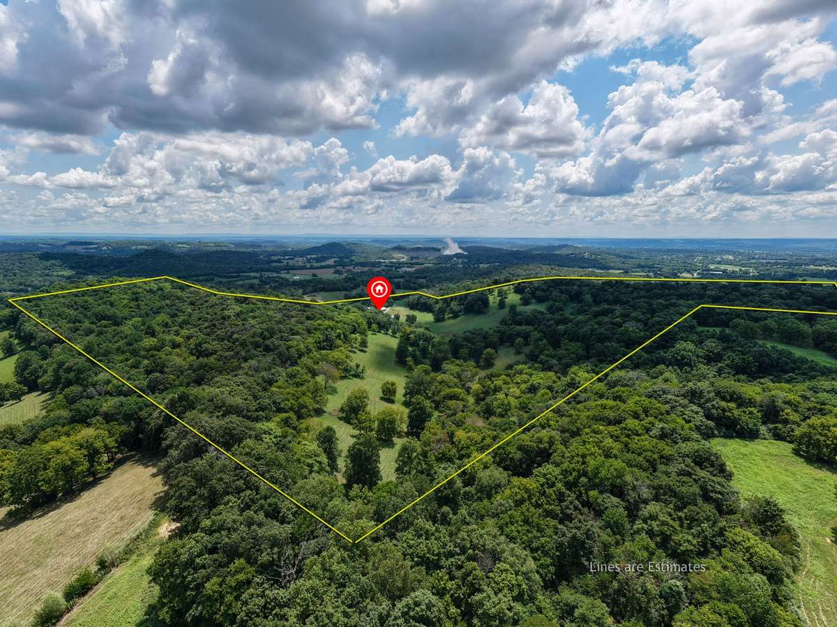 Aerial view illustrating the expansive acreage and rolling terrain, with approximate property boundaries shown for reference only.