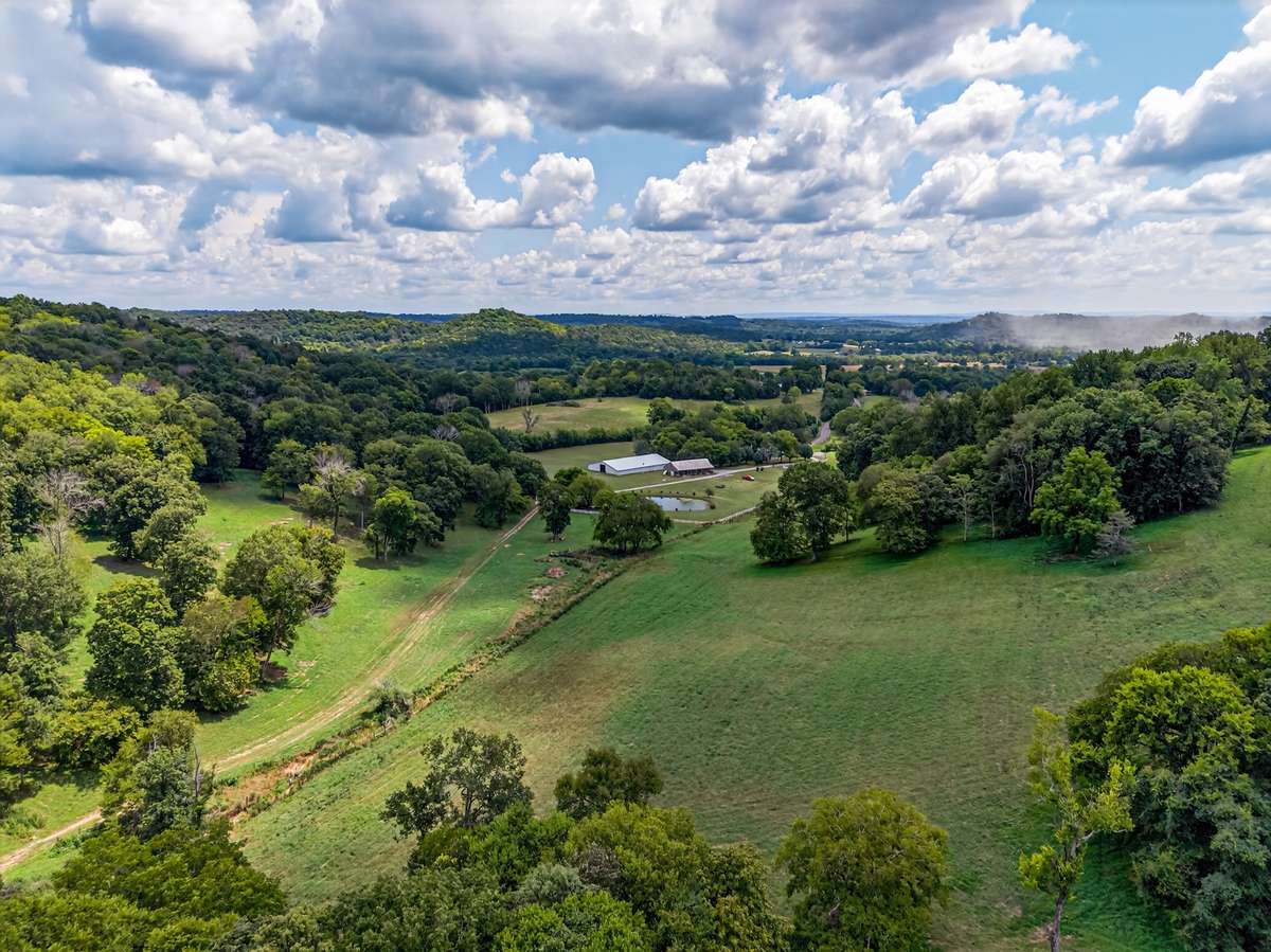 Rare large-acreage offering with rolling pasture, wooded ridgelines, pond, and established improvements—an exceptional legacy property in Lincoln County.