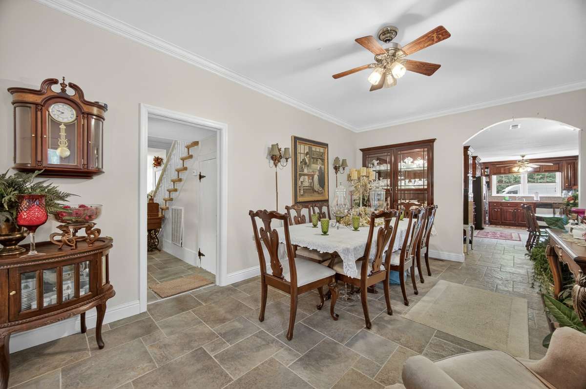 Formal dining room offering comfortable space for hosting and everyday use, with natural flow to adjacent rooms; furnishings may be included, partially included, or removed based on buyer preference.