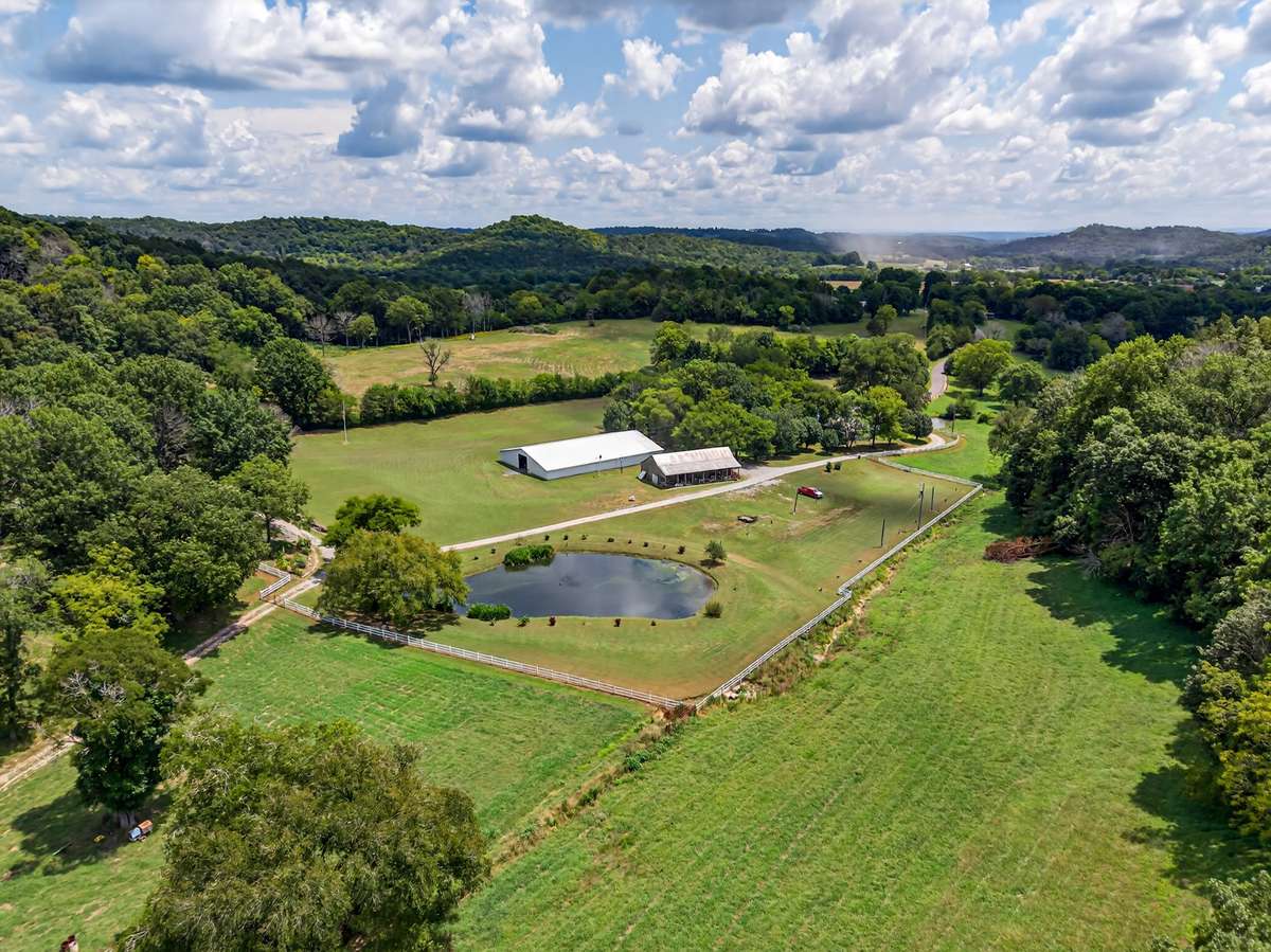 Aerial overview of Shadow Valley Farm, displaying open event fields, stocked pond, pavilion area, RV infrastructure, and natural landscape—ideal for a private estate, farm, or event venue.