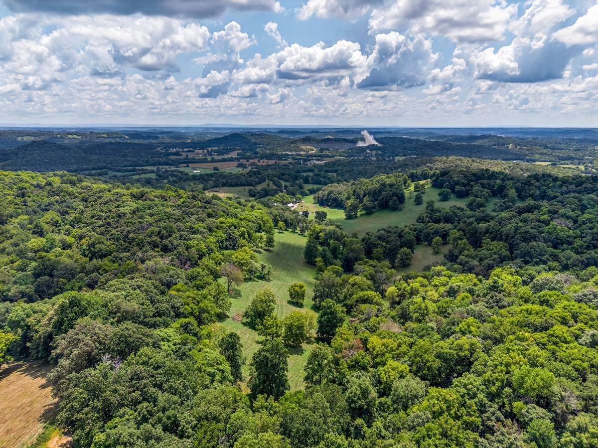Aerial overview of Shadow Valley Farm, featuring open event fields, stocked pond, pavilion area, RV infrastructure, and natural landscape—ideal for a private estate, farm, or event venue.