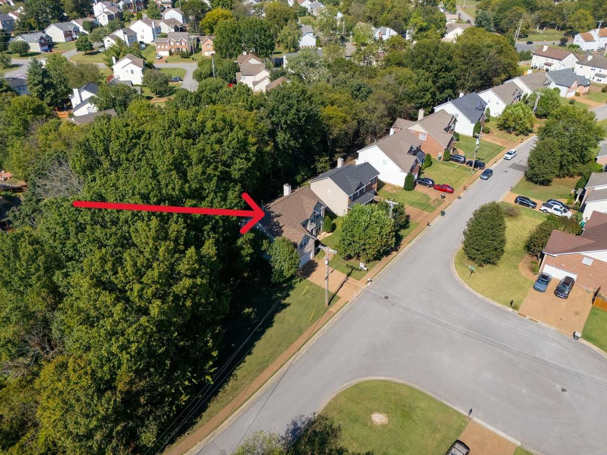 Aerial view of home. . .common area beside for more area to play and backs to wooded area for privacy!  Great cul-de-sac across the street