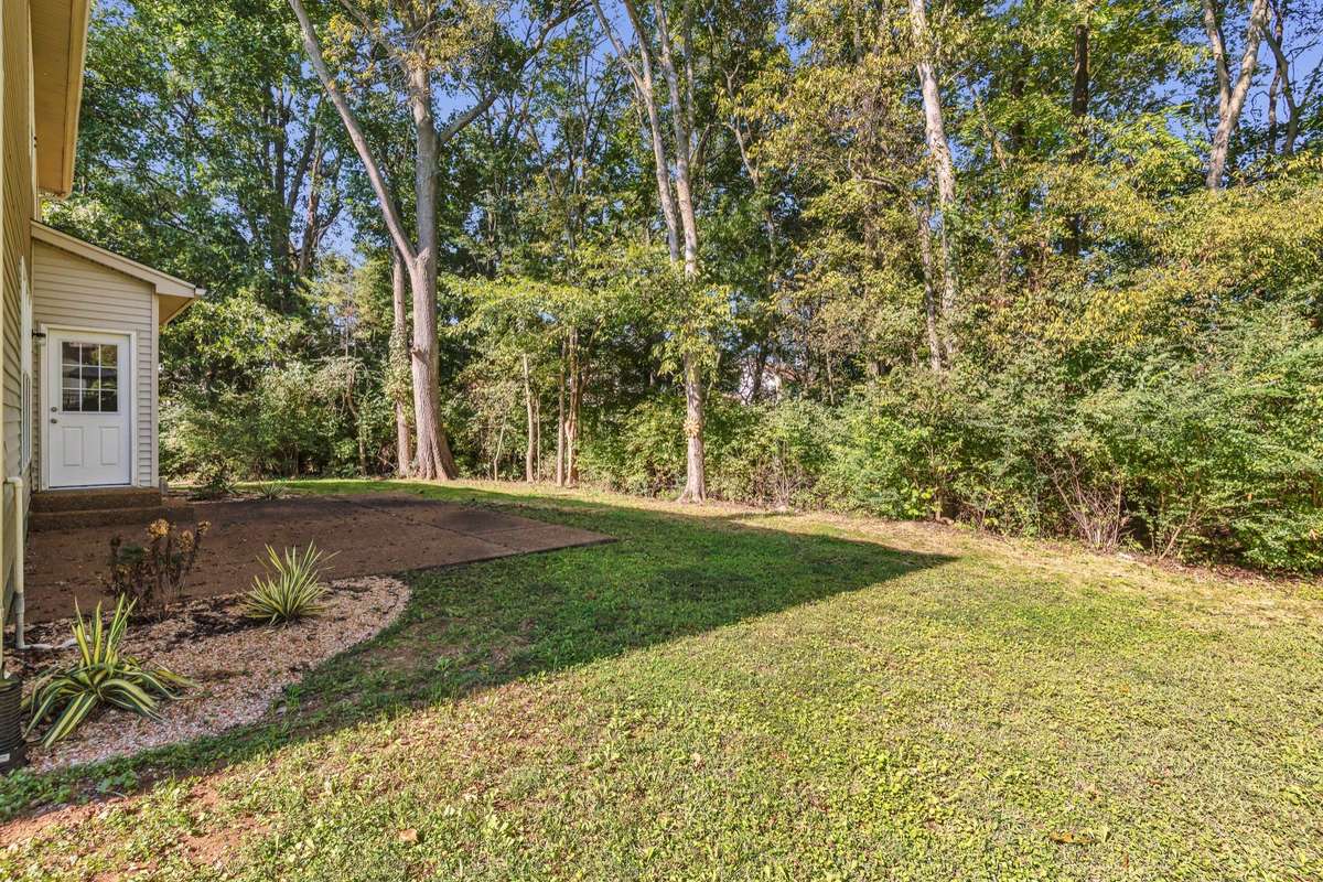 Backyard is wonderful private!  Door leads into the kitchen dining area. . . only a couple steps!