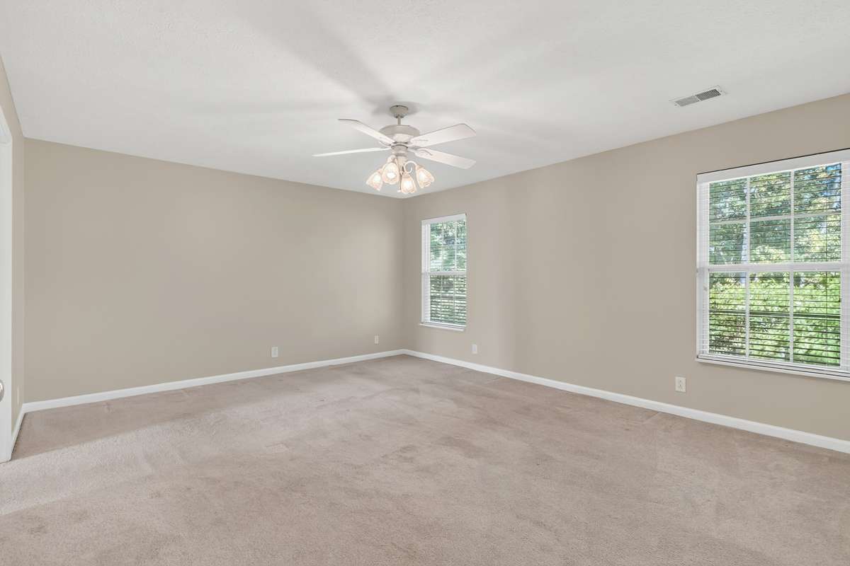 Huge primary suite is a must see with two ceiling fans, fireplace with gas logs, sitting room, huge bathroom and tons of closet space