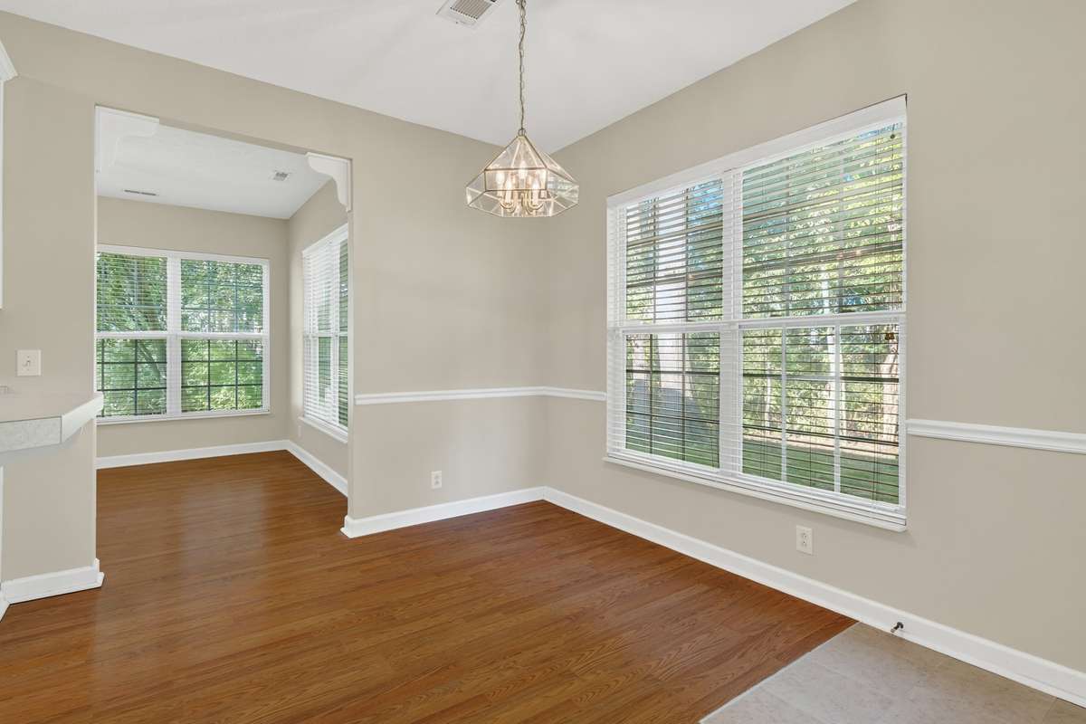 Kitchen eat-in dining area has door that leads to private backyard with ceramic tile flooring has you walk inside.  Off the kitchen in a fantastic sunroom with ceiling fan, lots of windows and wood floors