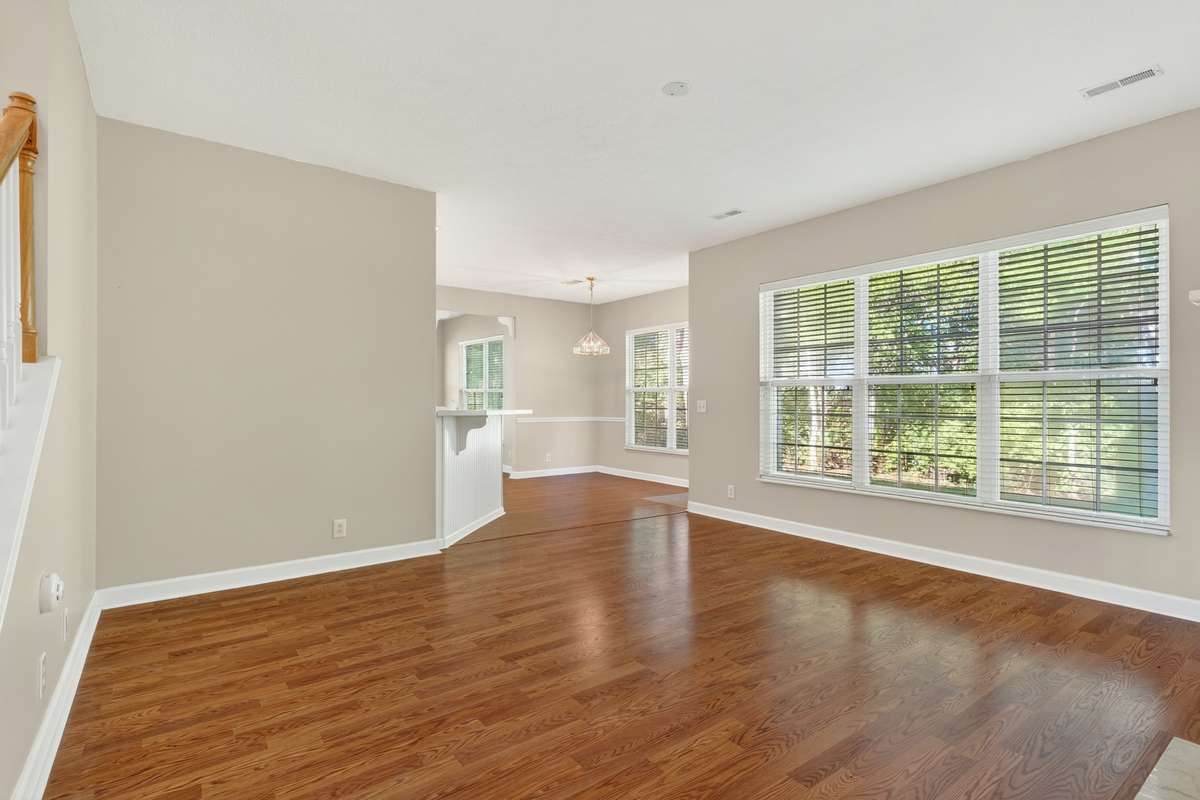 Family room open to the kitchen with tons of natural light and wood floors.  Beautiful view out the windows with all trees!