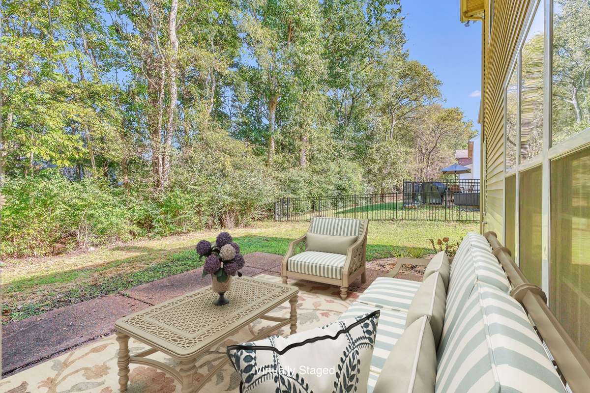 Huge patio overlooking backyard. . Virtually Staged