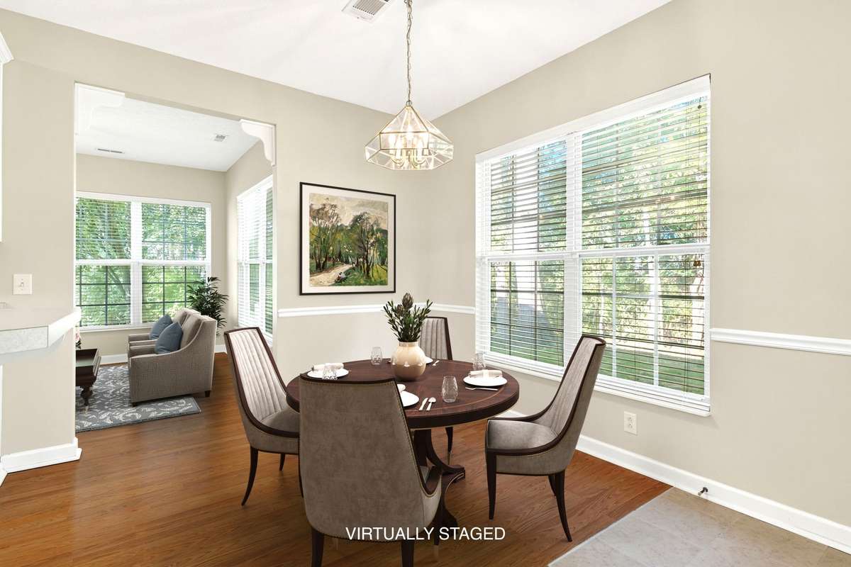 Kitchen dining area Virtually Staged. . .  with sunroom in the back.