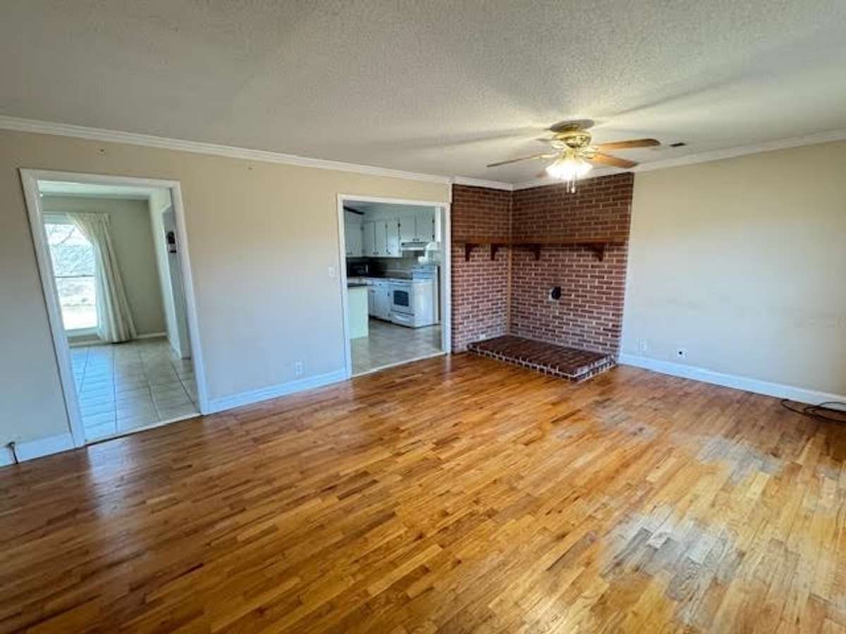 Living room with space for a wood stove. Don't get caught without heat in the next ice storm.