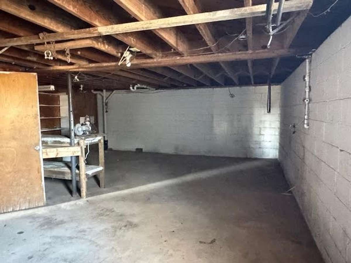 Basement garage with a shop area at the rear.