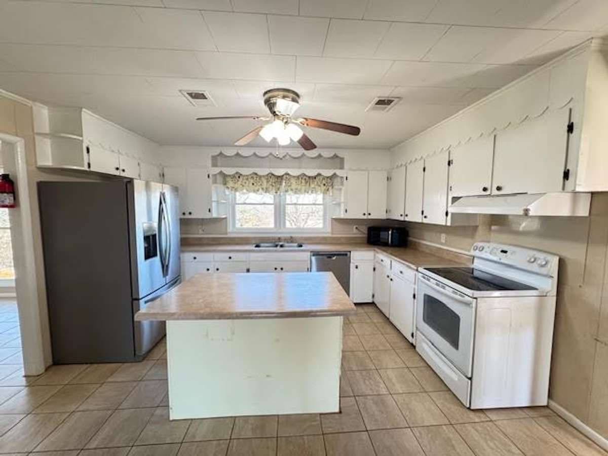 Kitchen has an island for extra storage and those family get togethers