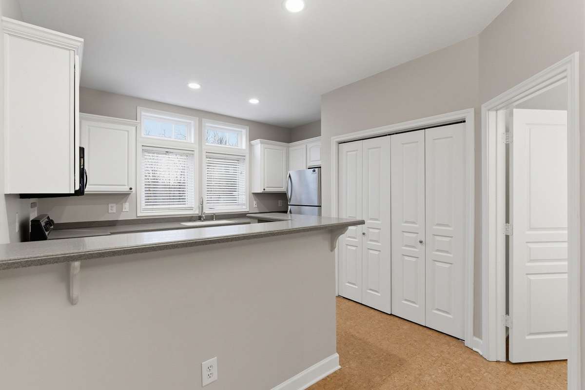 The breakfast bar offers additional prep space. An open layout allows for easy flow to the adjoining living area.