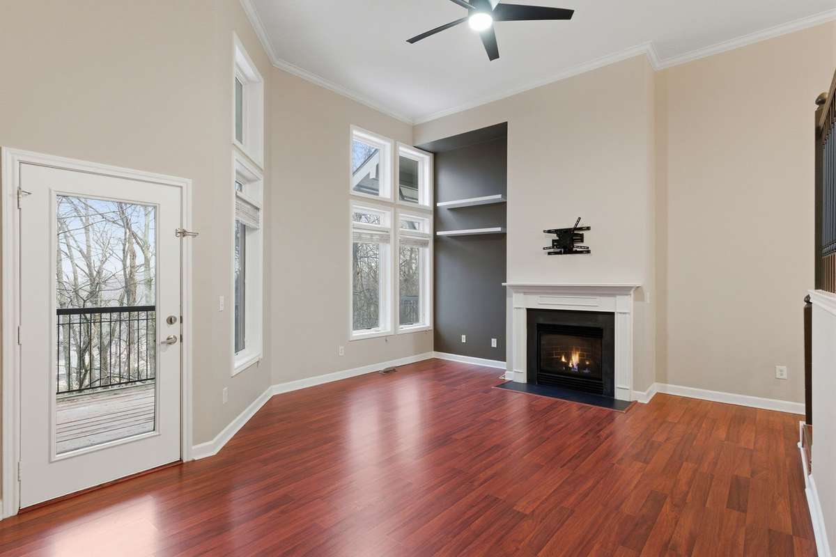 Featuring a cozy gas fireplace, stylish open shelving, and beautiful natural light.