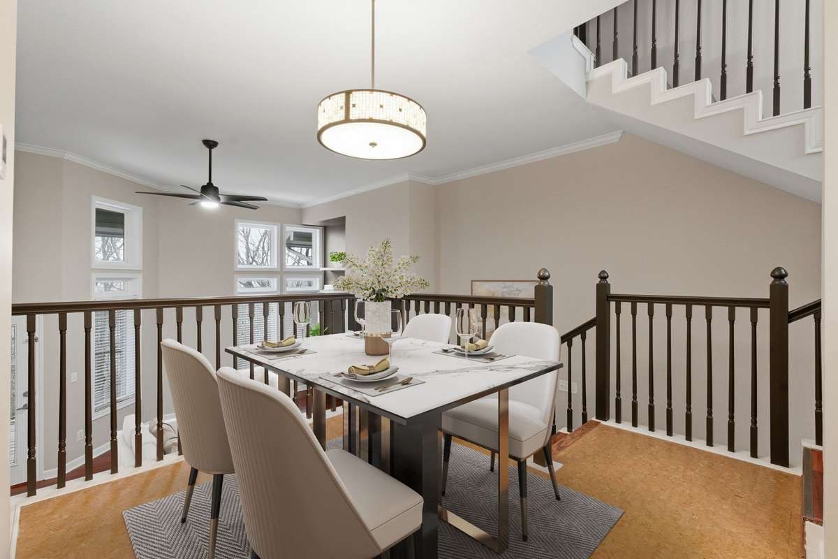 Just steps up from the living area is the dining area, which flows seamlessly into the kitchen. (Virtually staged.)