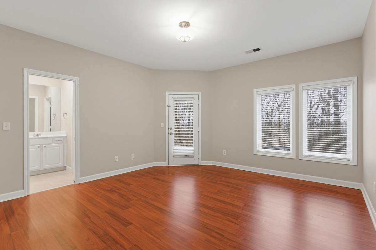 This spacious bedroom features two walk-in closets, a full bath and direct access to a covered patio, creating a comfortable, versatile space ideal for guests or extended living.