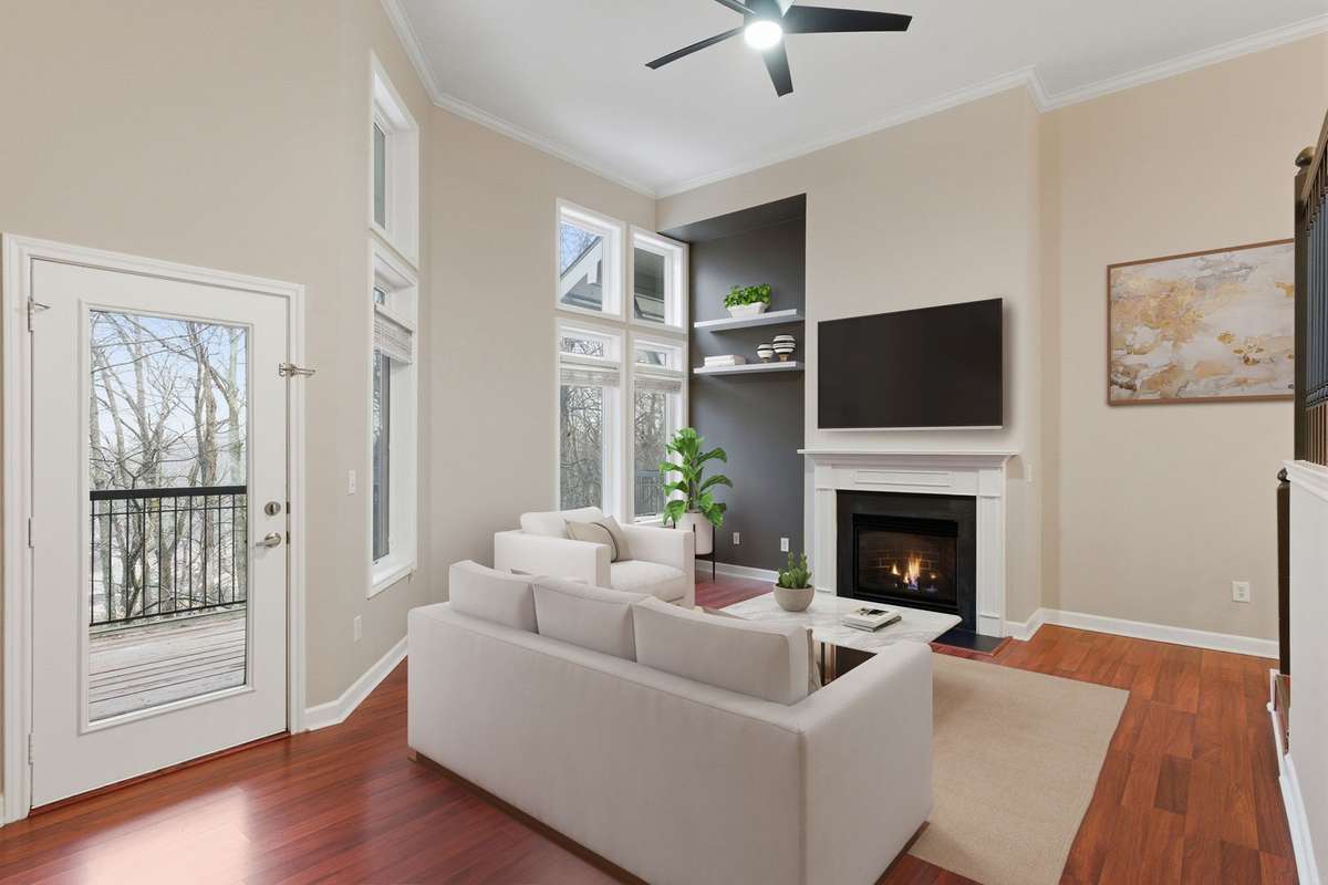 Additional view of the living area highlighting access to the private balcony. (Virtually staged.)