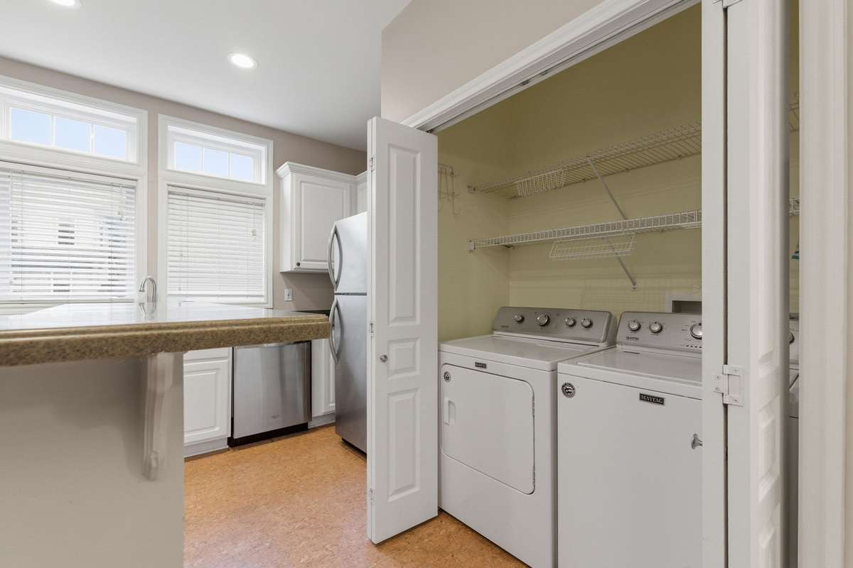 Generous laundry closet with washer and dryer to remain.