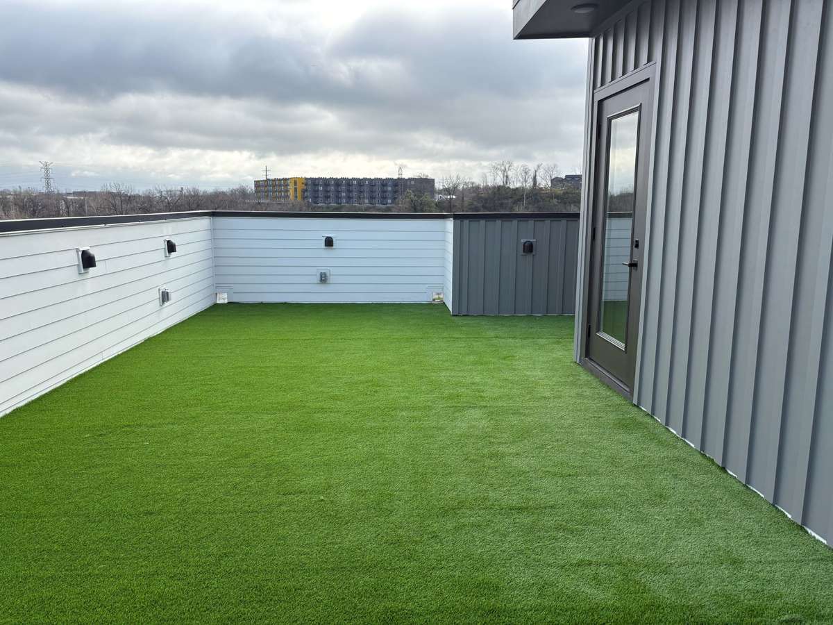 Custom rooftop turf creates a clean, low-maintenance outdoor retreat with year-round greenery.