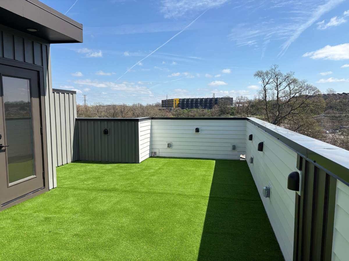 Custom rooftop turf creates a clean, low-maintenance outdoor retreat with year-round greenery.