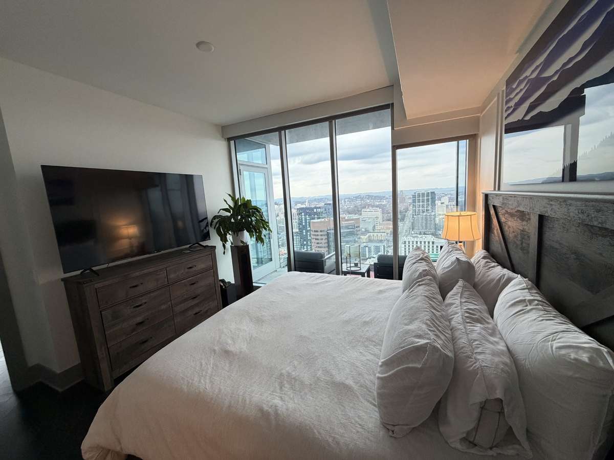 primary bed with balcony from living room