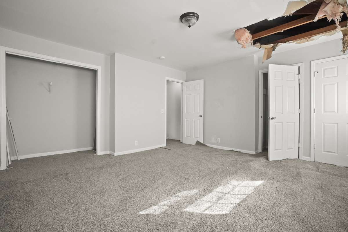 Primary bedroom currently has hole in ceiling from previous roof leak. Roof has been repaired. Hole in ceiling has not yet been repaired since new roof was installed.