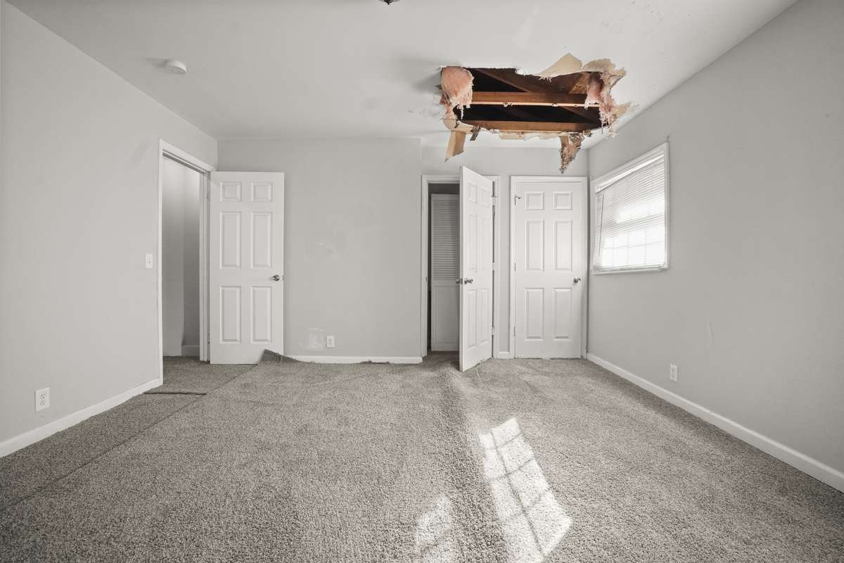 Primary bedroom currently has hole in ceiling from previous roof leak. Roof has been repaired. Hole in ceiling has not yet been repaired since new roof was installed.