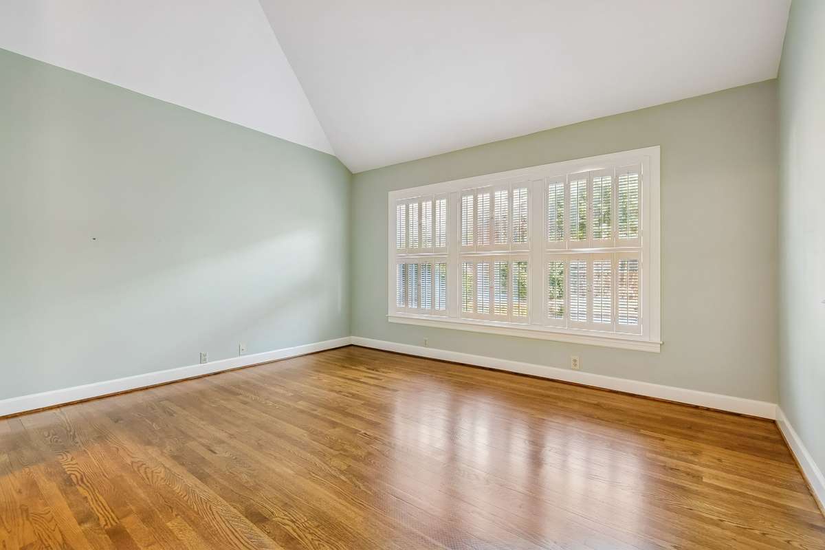 Bright Master Bedroom with custom shutters and vaulted ceiling