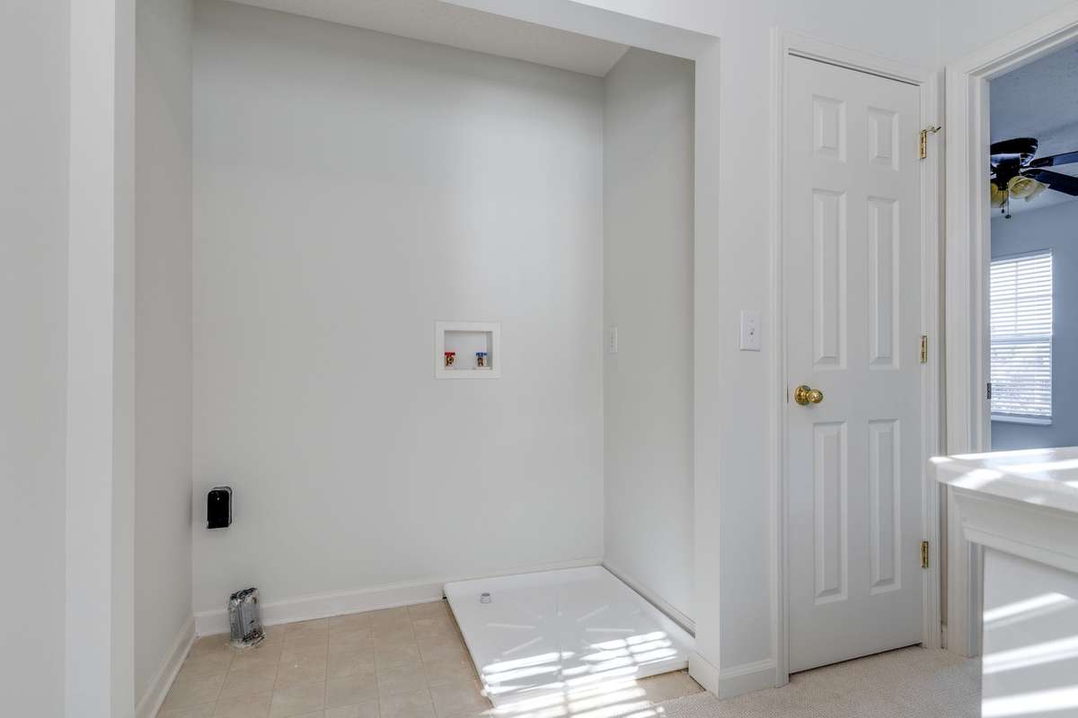 The laundry closet has a new washer pan and fresh paint. The closet to the right is great linen storage. There's also a pull down attic over this space with flooring for storage.