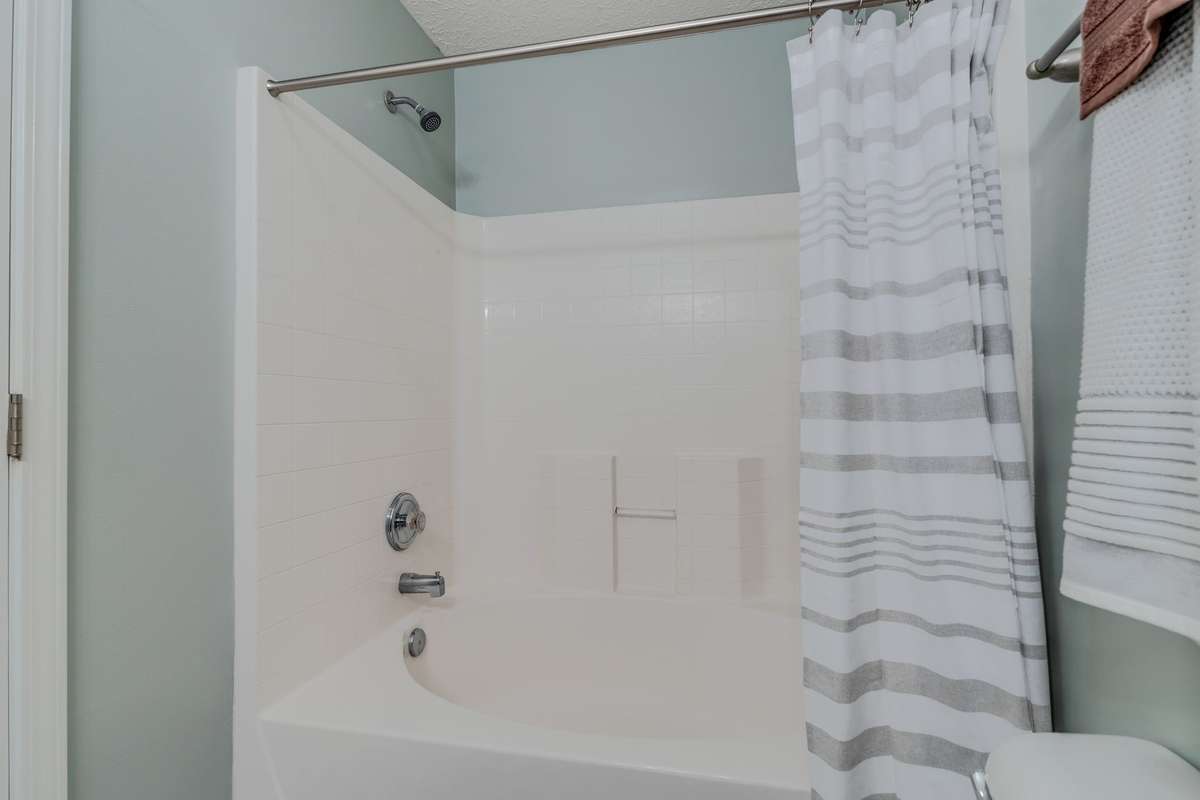 The primary bath offers a garden tub/shower combo.