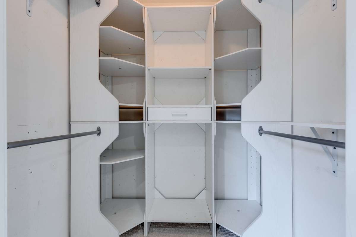 The primary closet has been built-out with additional shelving and storage.
