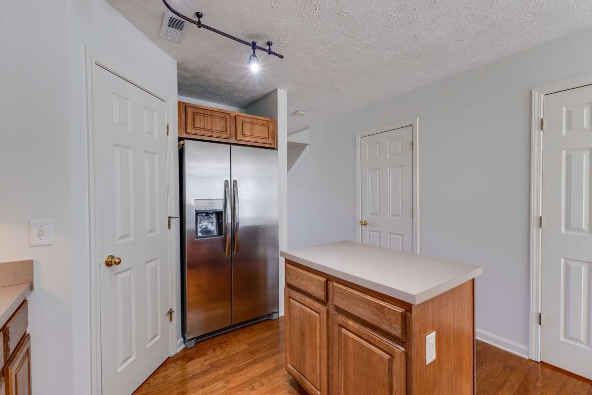 The stainless steel refrigerator is new and remains with the home.