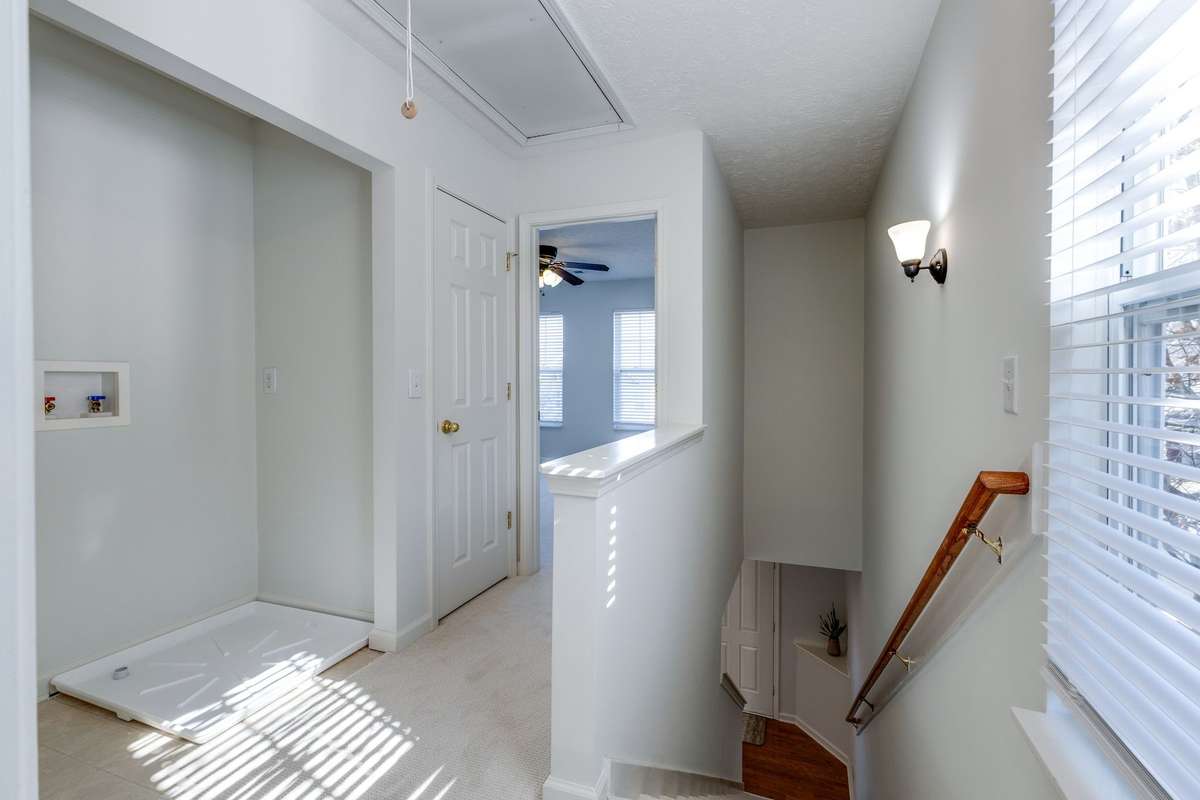 Upstairs, you'll find a small hallway leading to the two bedrooms and the laundry hook ups.