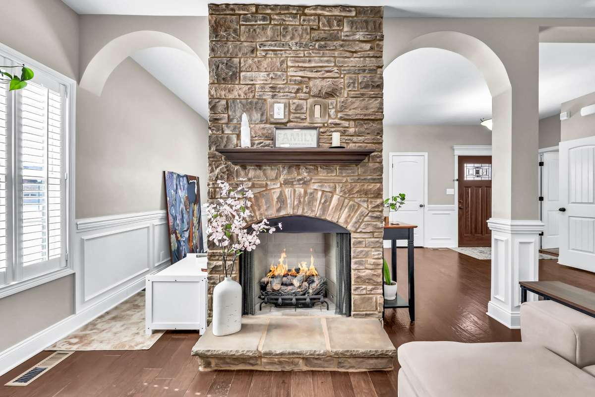 FIREPLACE BETWEEN THE GREATOOM AND THE FORMAL DINING ROOM