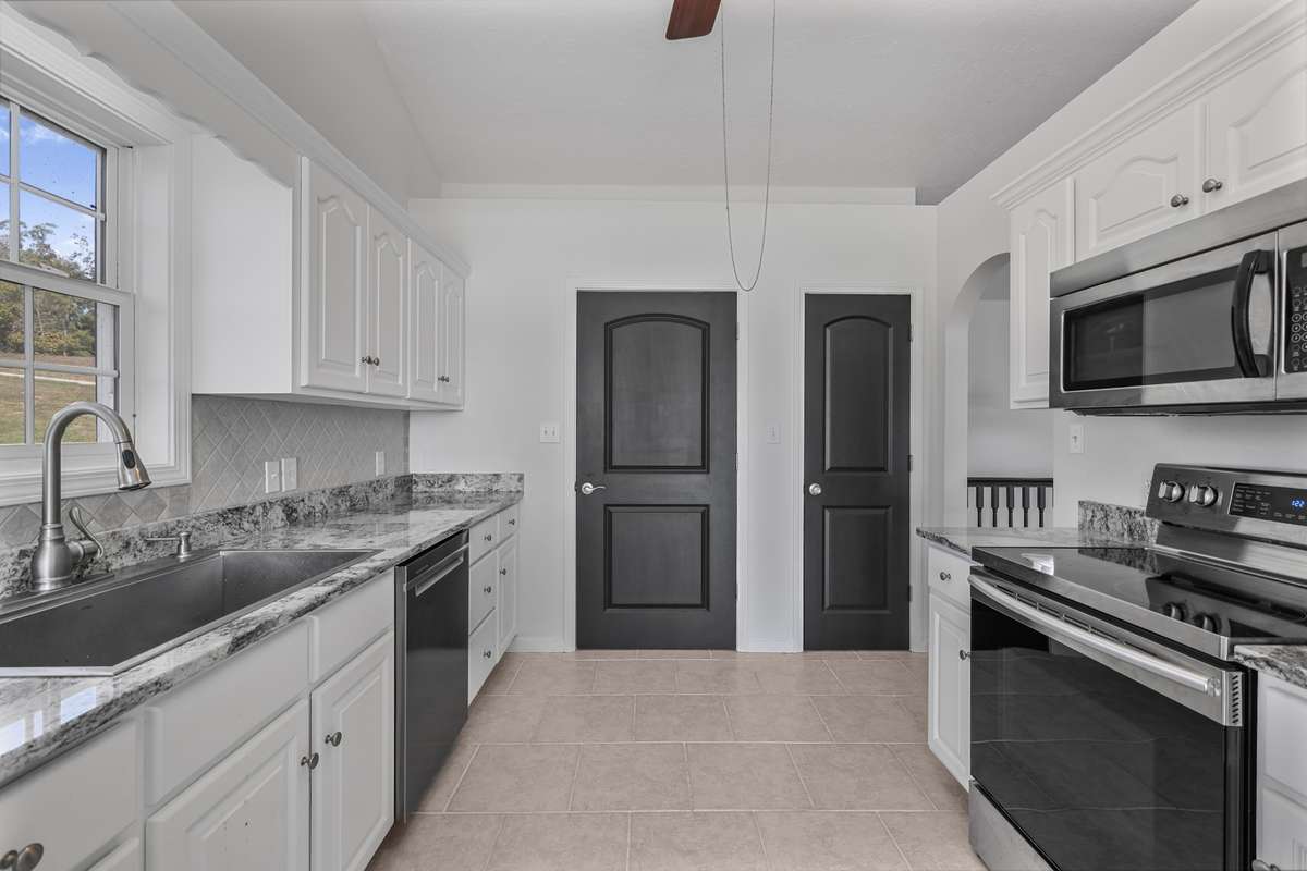 Updated primary kitchen with granite and stainless appliances