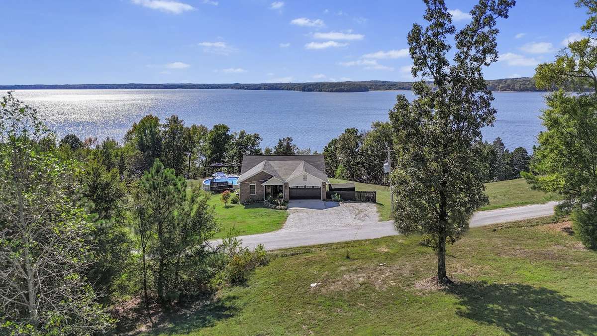 Aerial view highlighting privacy and lake access.