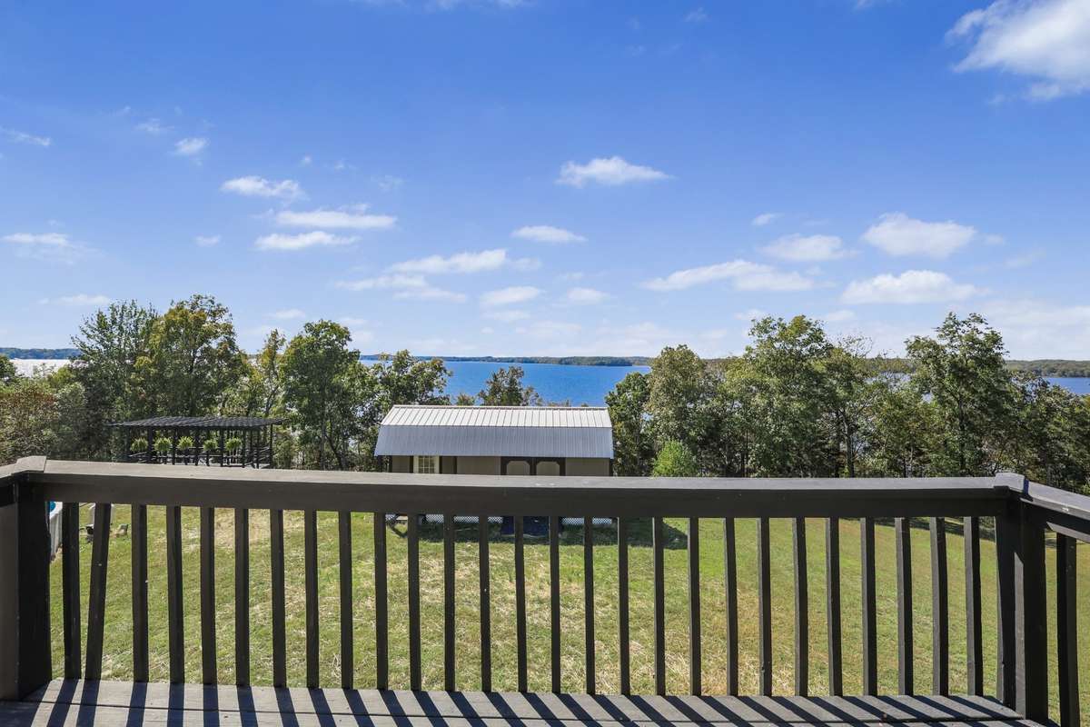 Dining room balcony overlooking the lake and 1-acre lot
