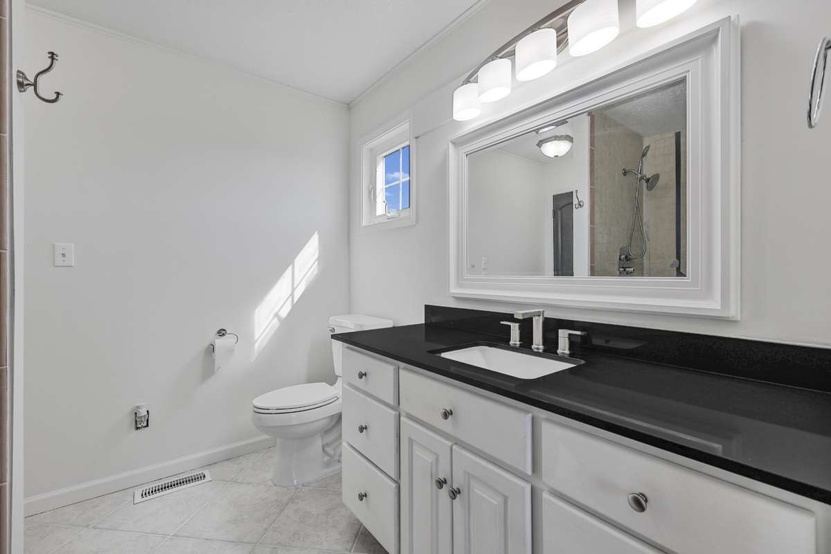 Upstairs primary suite with black quartz countertops
