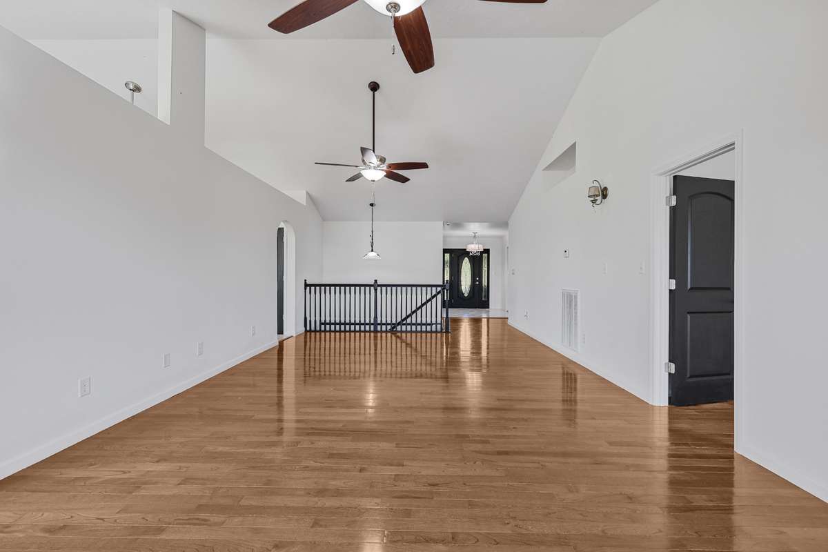 Second view of the spacious living room with vaulted ceilings