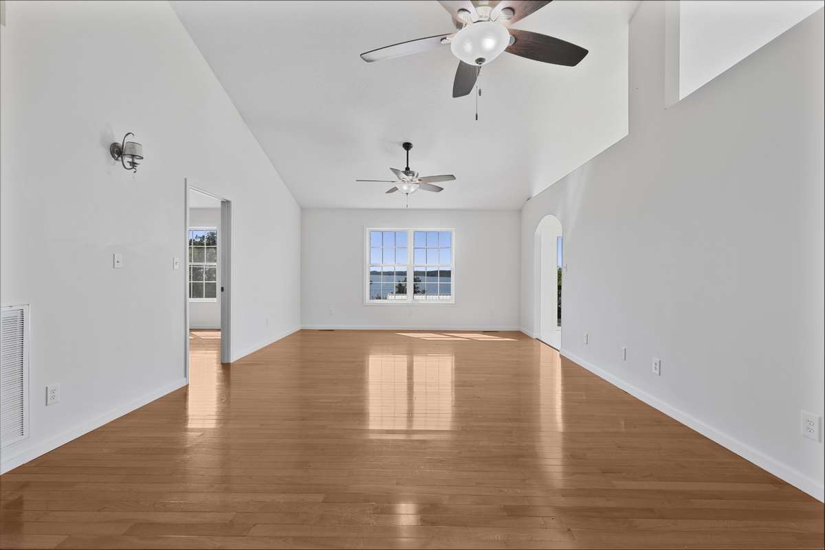 Spacious living room with vaulted ceilings and abundant natural light