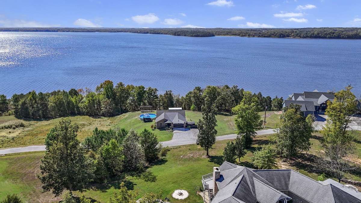 Aerial view of home and surrounding natural landscape.