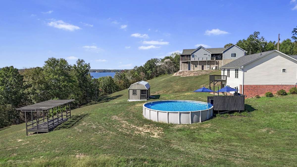 Open yard with pool, shed, and room to enjoy the outdoors.