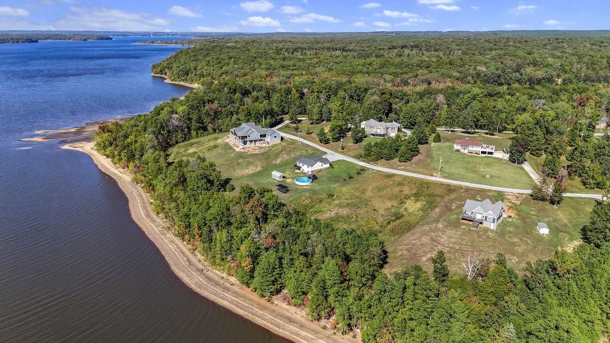 Private lakefront setting on a 1-acre lot with expansive water views and natural surroundings.