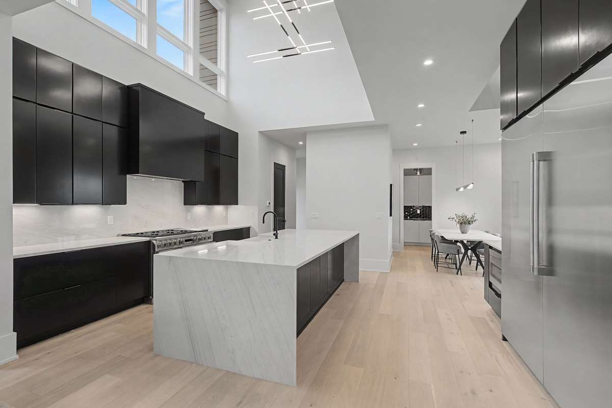 Commercial grade refrigerator and 48" double oven range.  20 ft ceilings with expansive windows in the main kitchen level.
