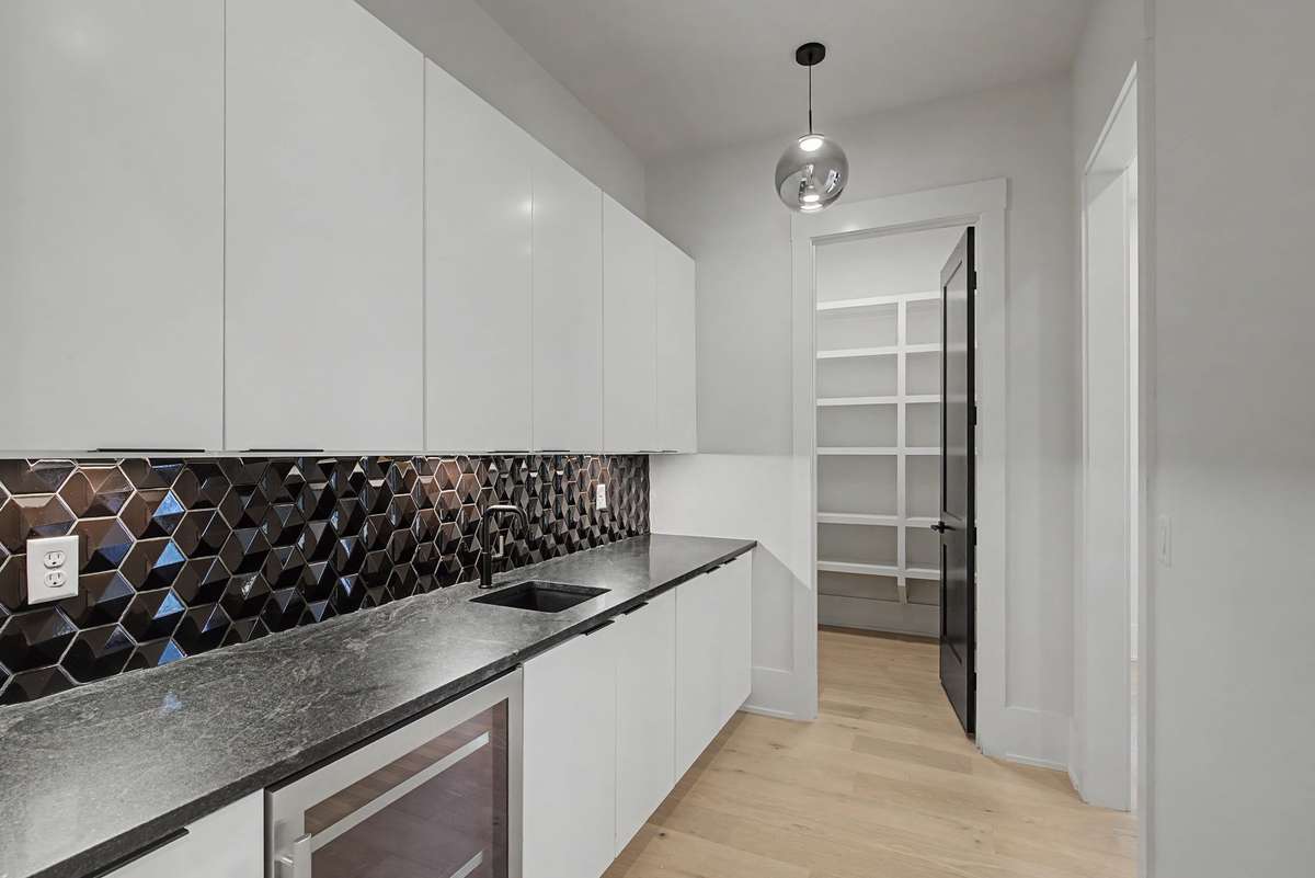 Butler's pantry with sink and wine fridge...huge pantry as well!