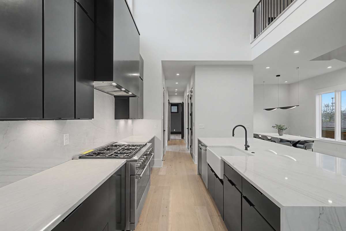 Waterfall island with additional storage cabinets on the backside.